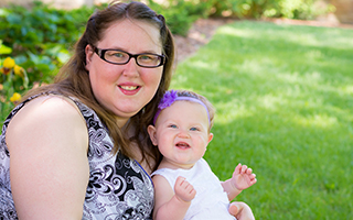 Woman smiling with her baby on her lap