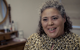 Woman in a leopard print shirt talking