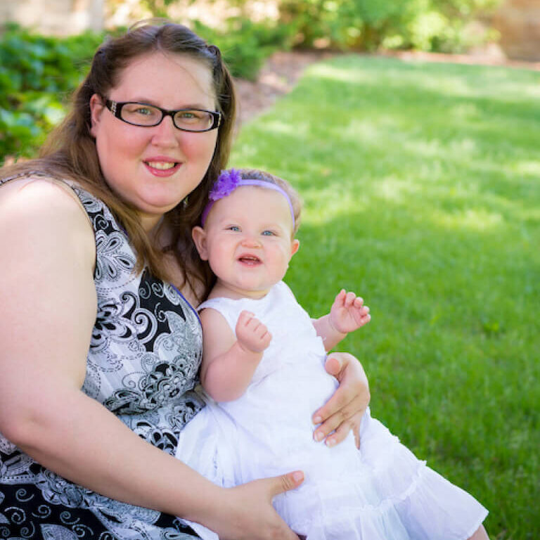 Happy mother and daughter together in the park on summer day