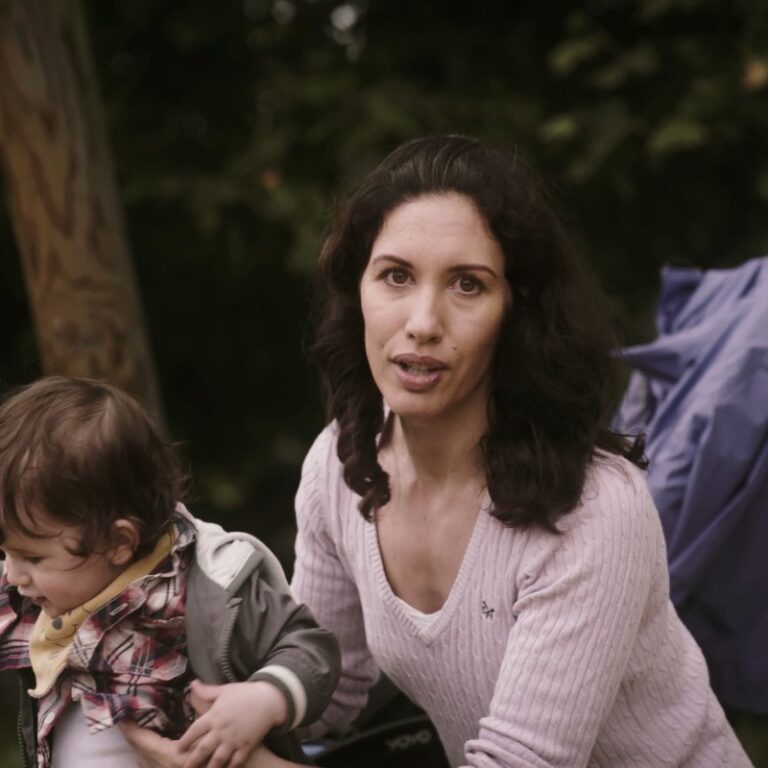 Brunette woman holding onto a toddler