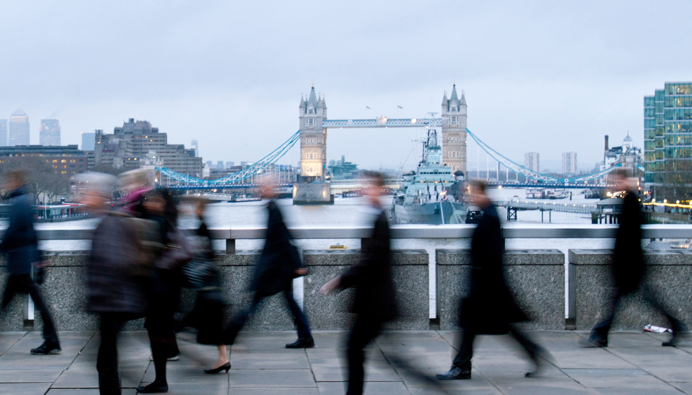 Commuters walking across London Bridge into the City