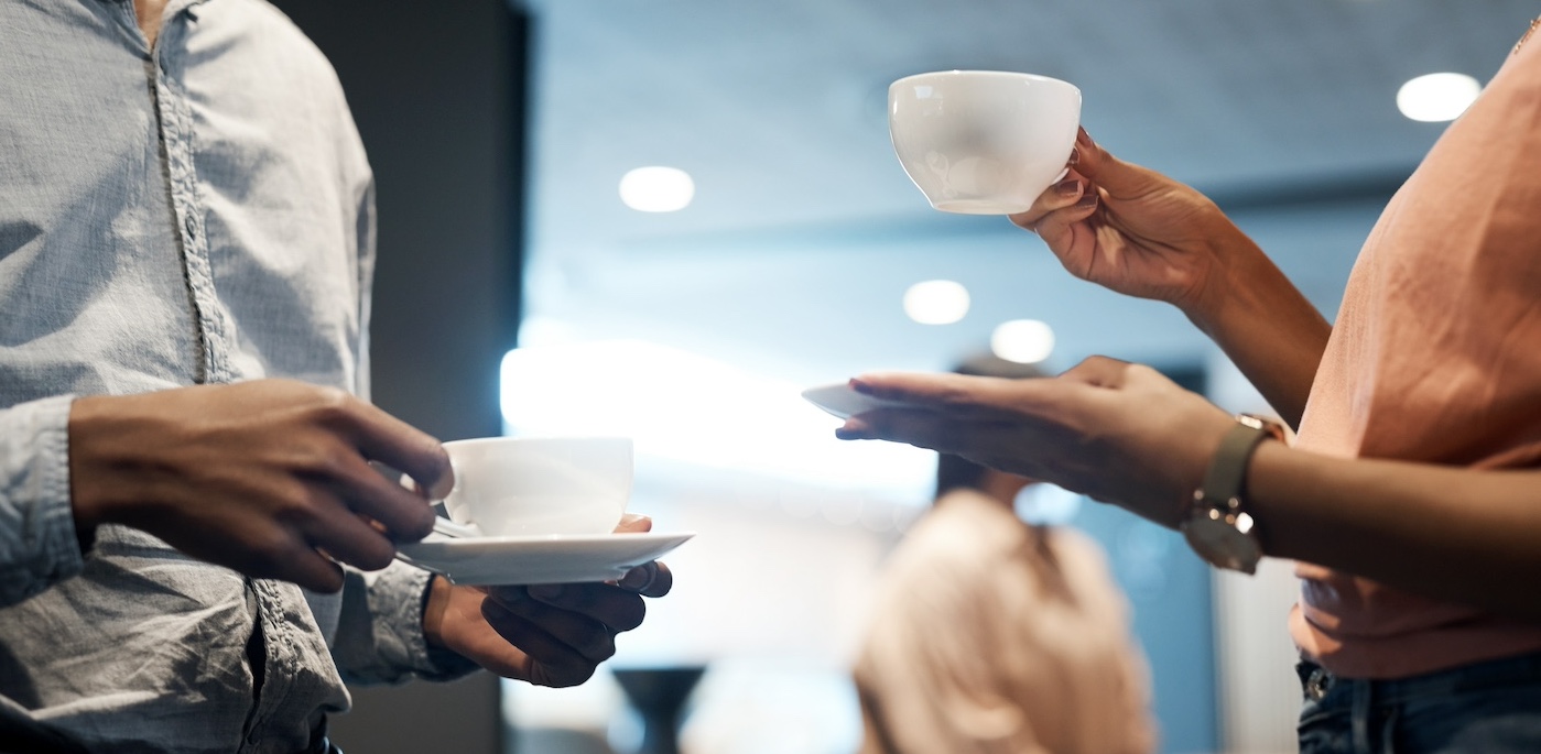 Two people holding coffee cups